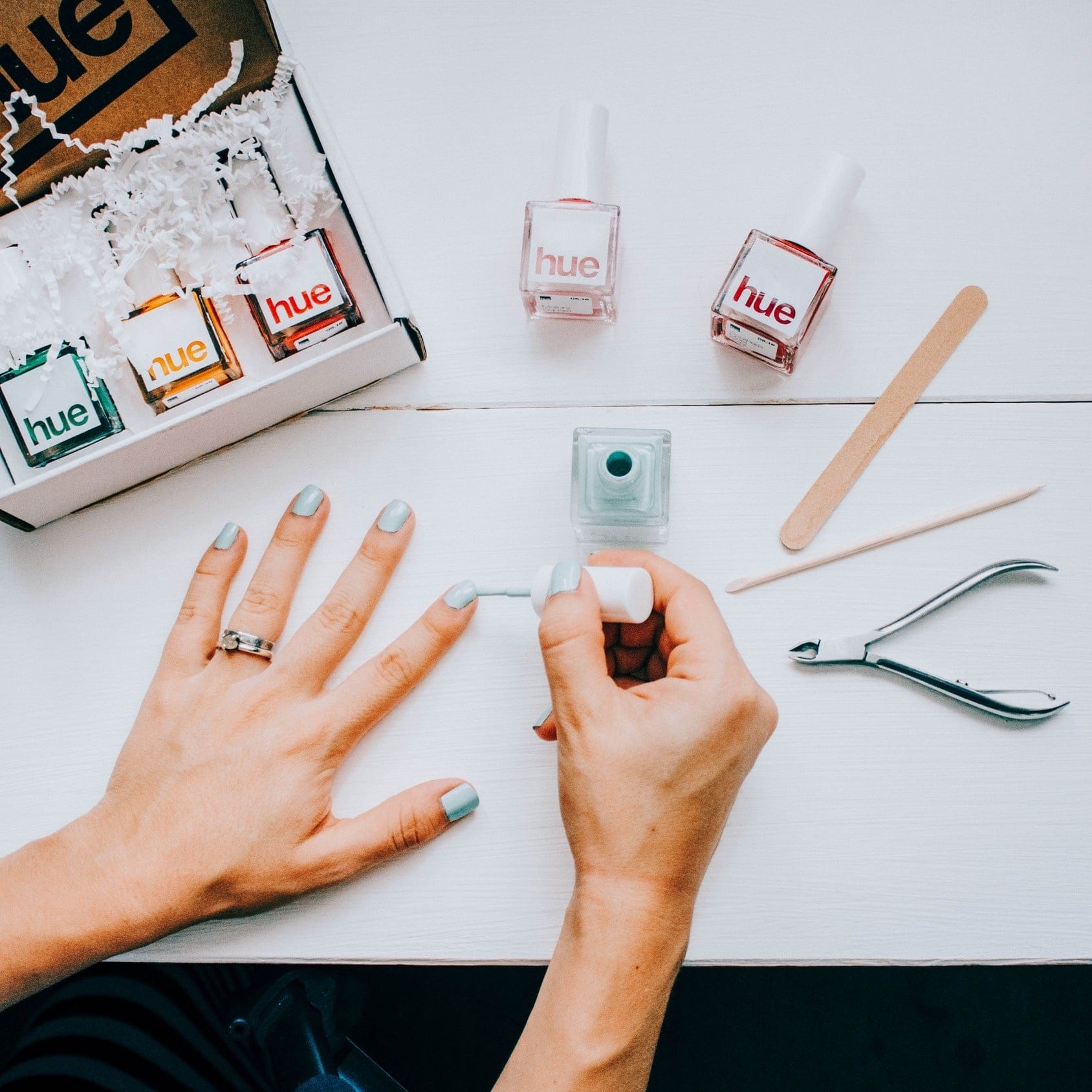 woman doing her nails on a desk