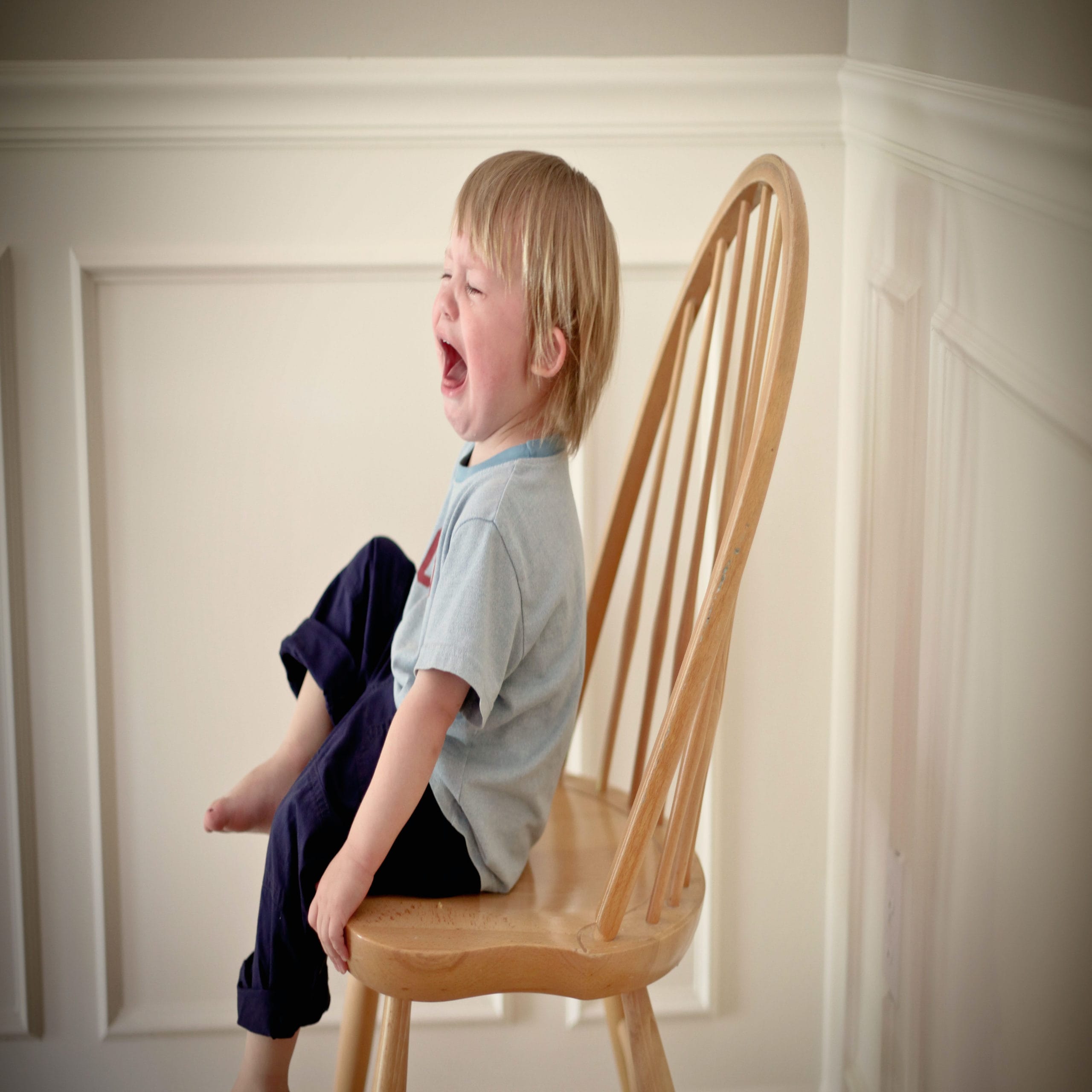 child screaming in a chair