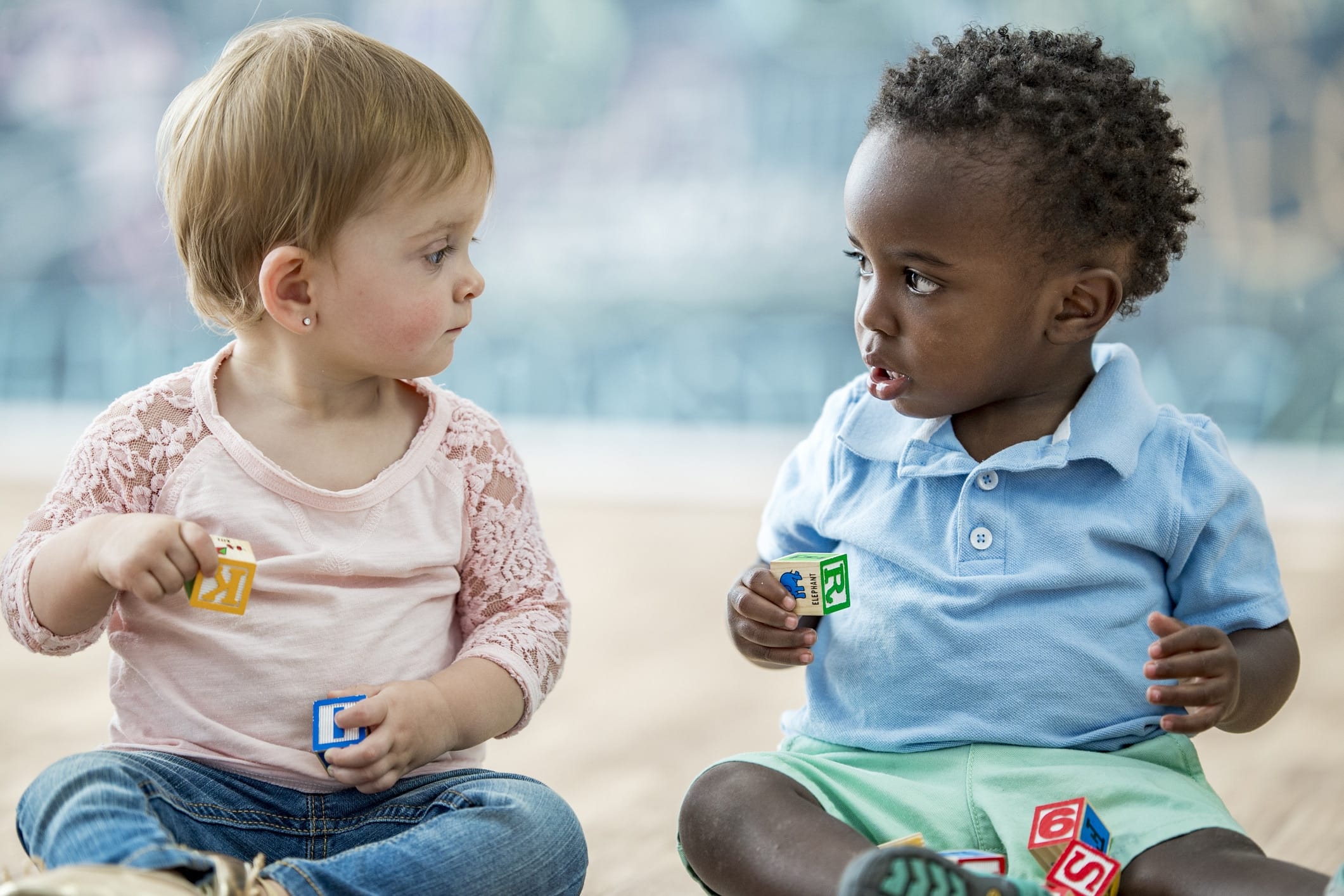 two babies sitting next to each other