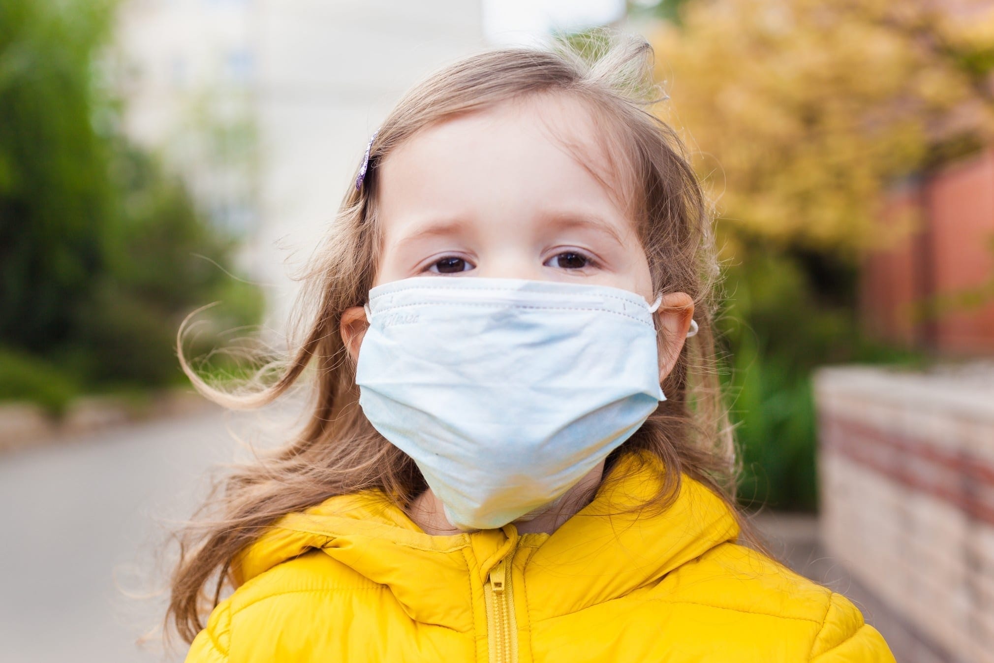 little girl wearing a mask