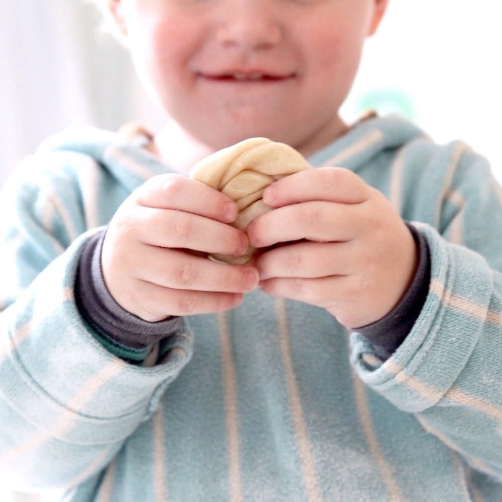 toddler holding a cookie in his hand