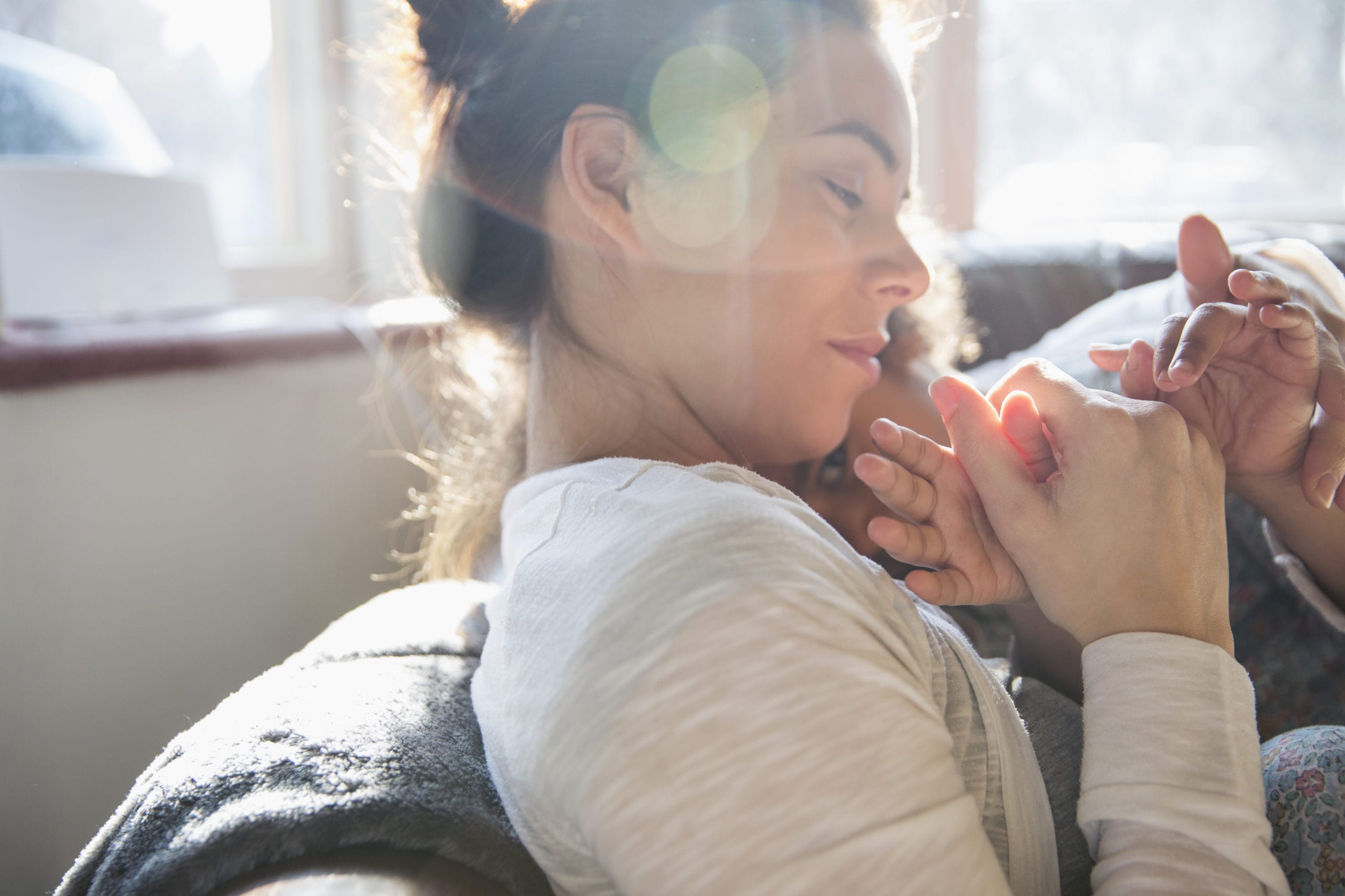 mom snuggling toddler in her arms