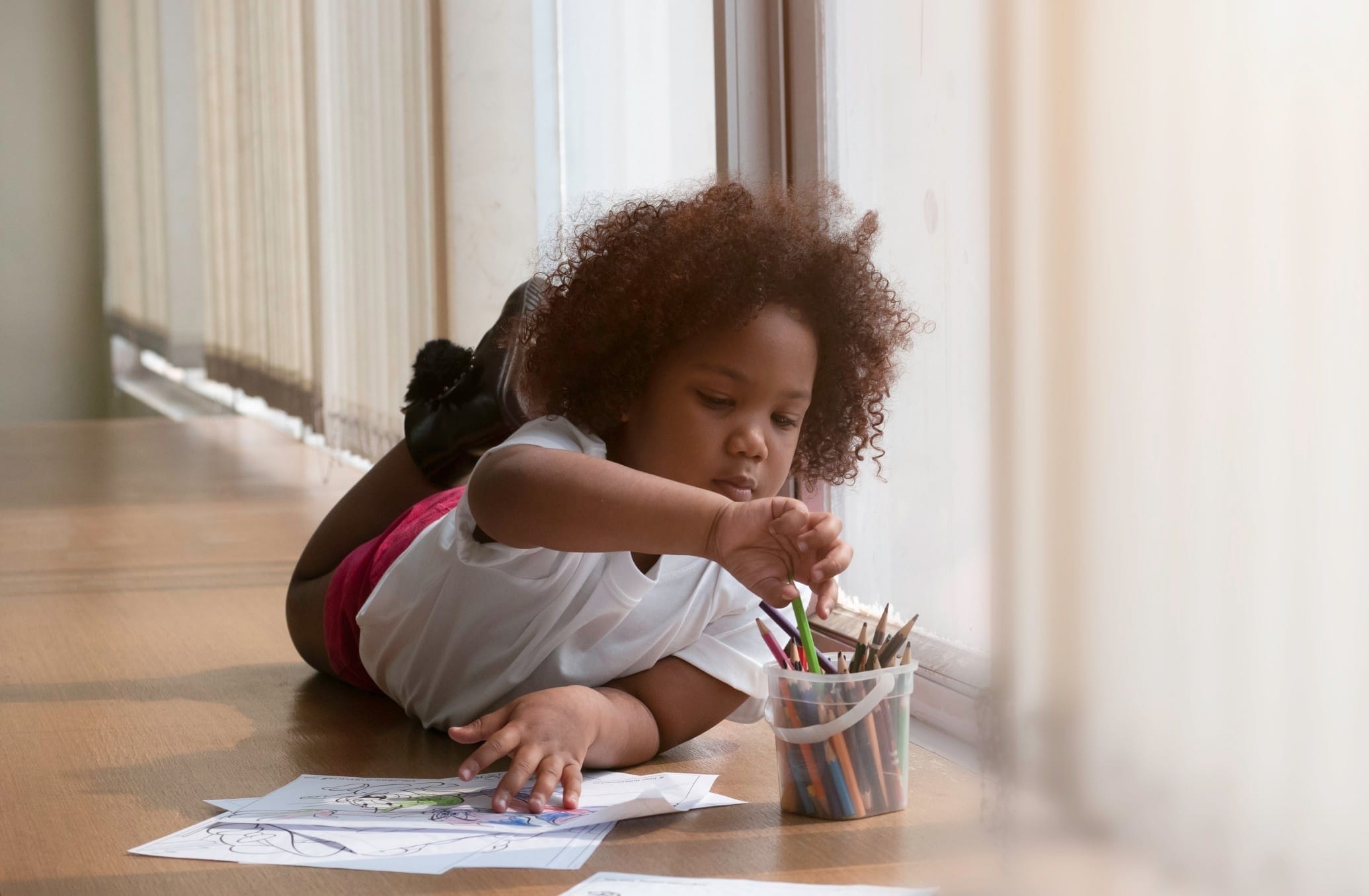 child coloring on the floor