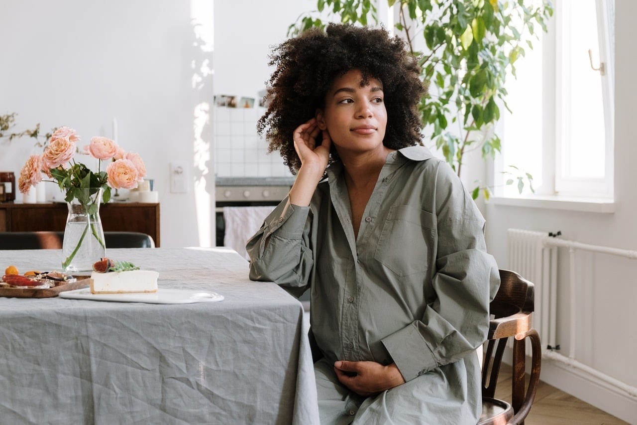 pregnant woman sitting at a table