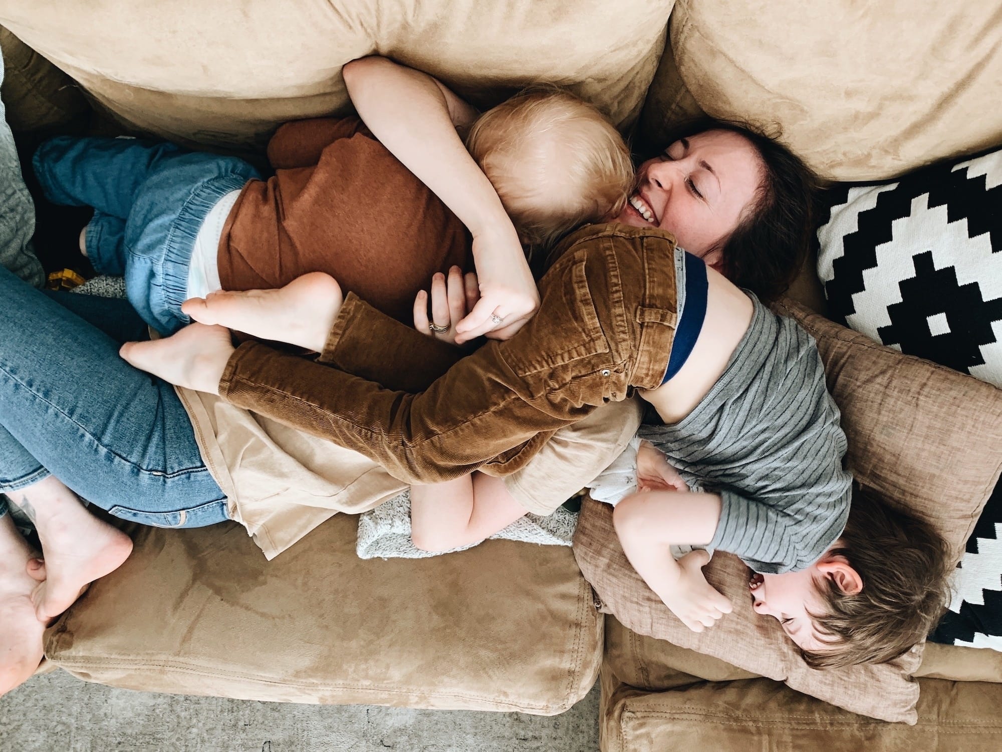 mom hugging kid on couch