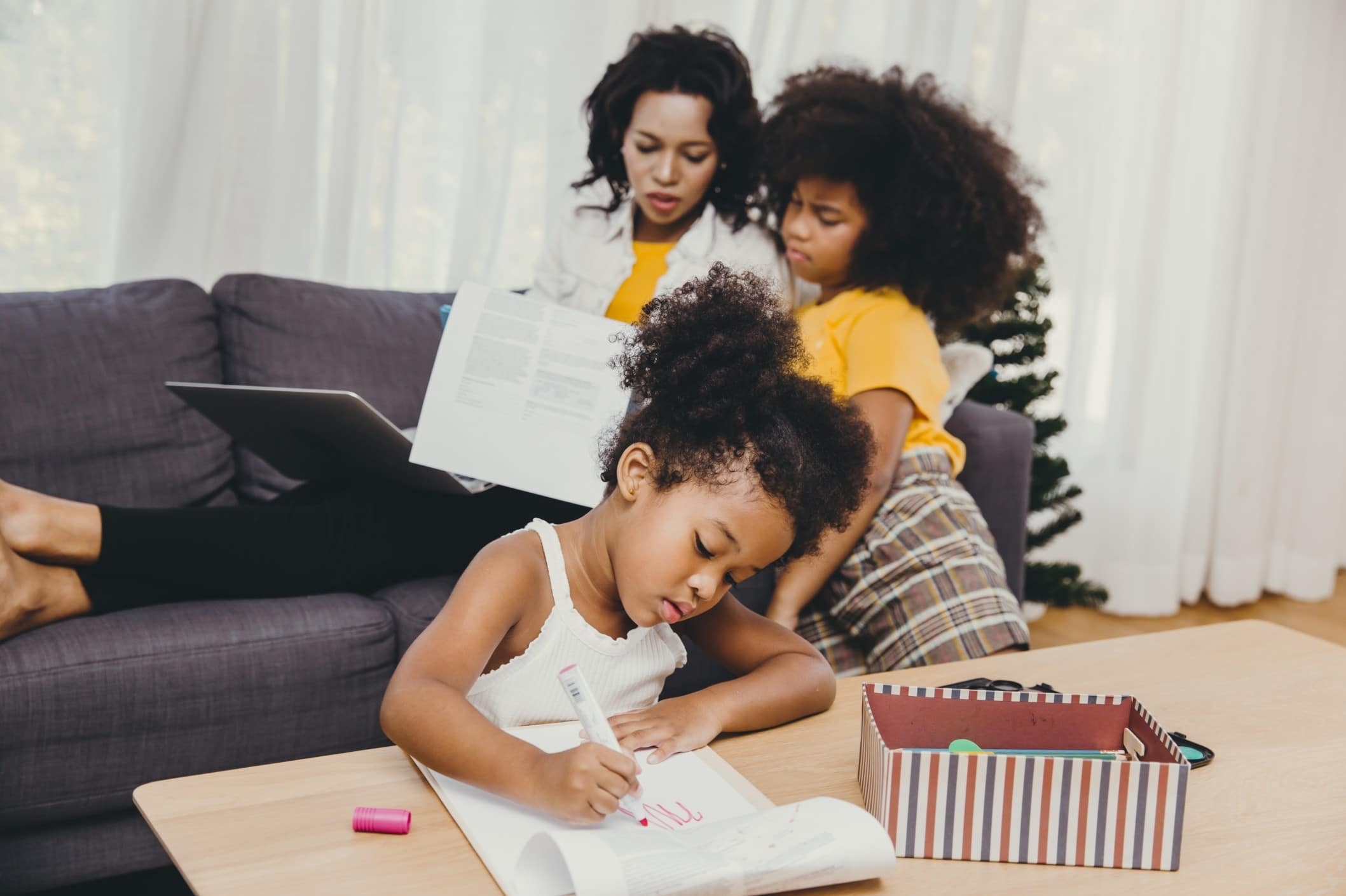 mom helping two daughters with school