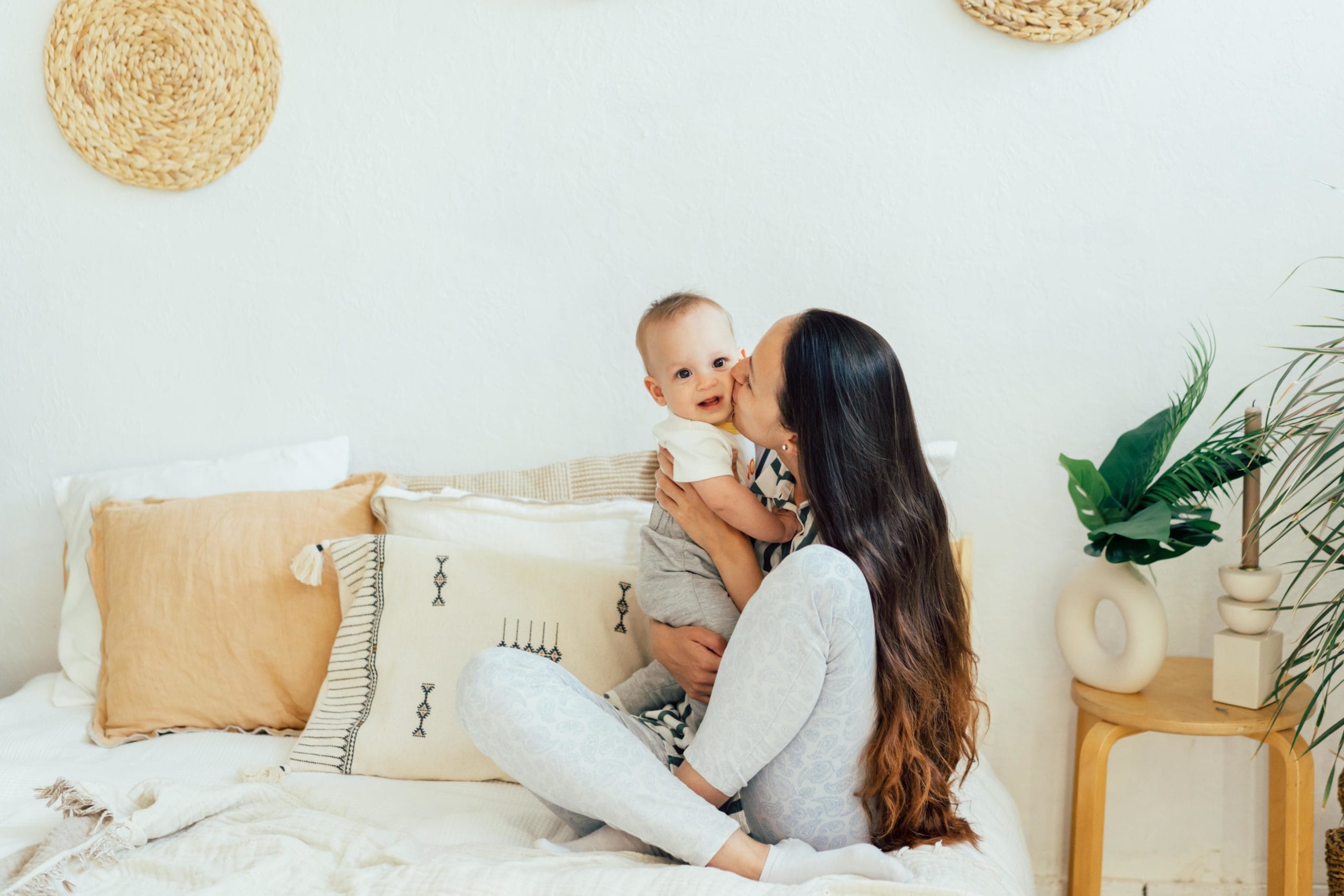 mom kissing baby on the cheek