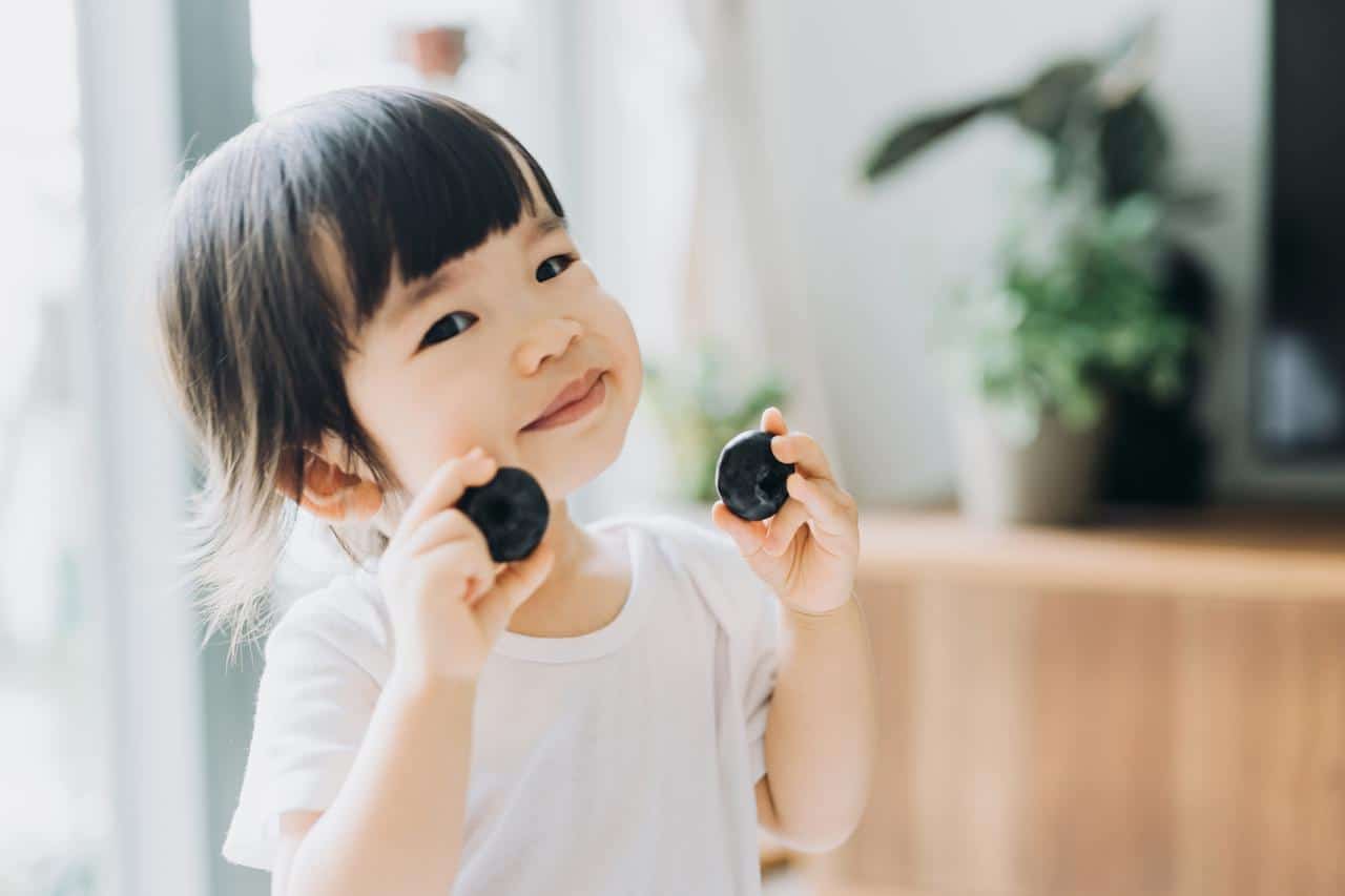 little girl holding snacks