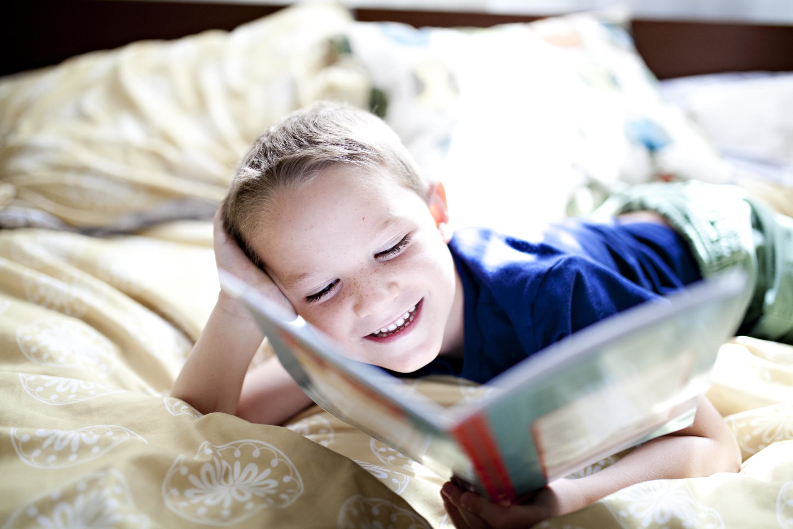 little boy reading a book