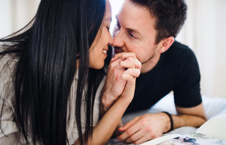 Couple holding hands and kissing