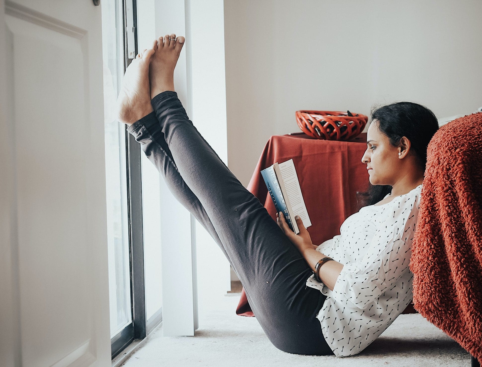 mom reading a book with her feet up