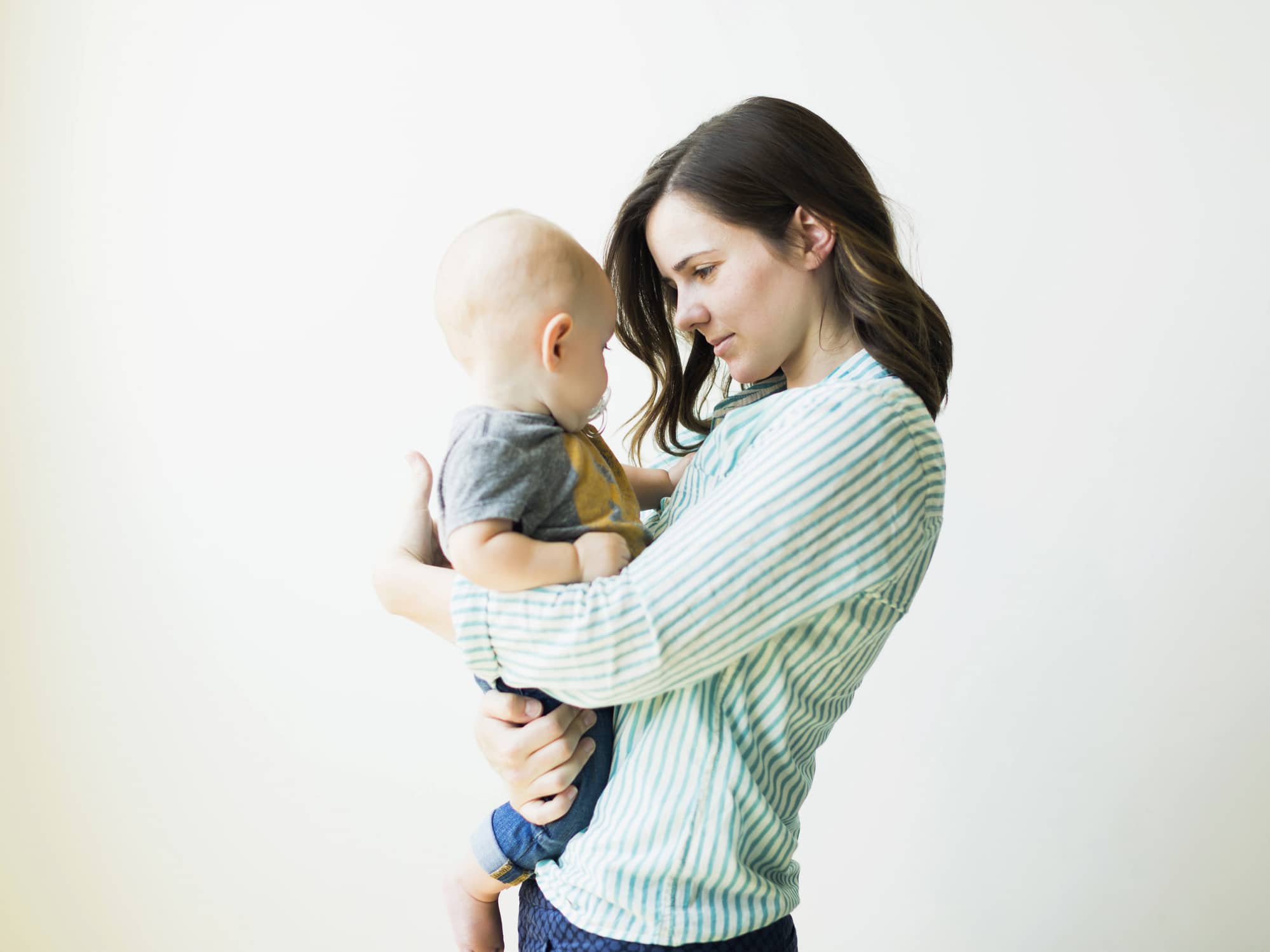 mom holding baby up to her