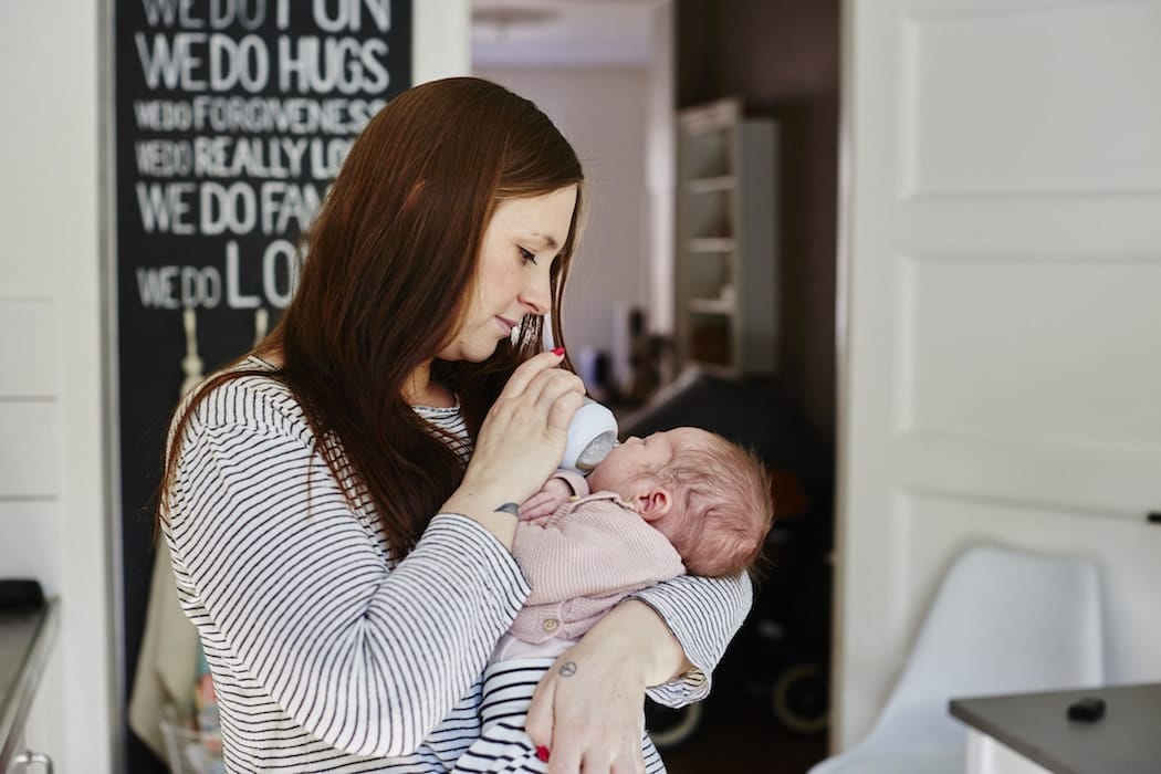 mom giving a newborn baby a bottle