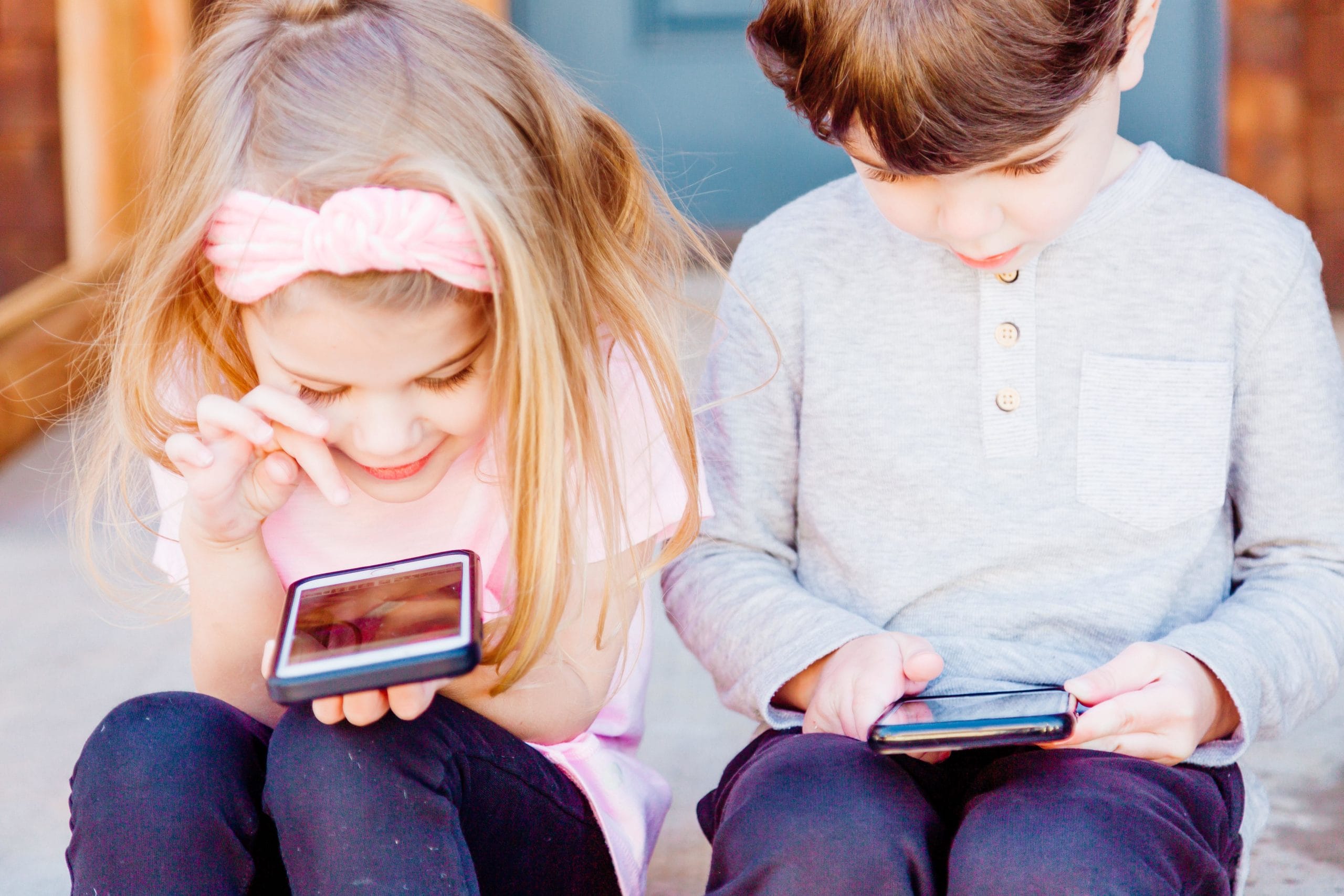 little kids playing on phones