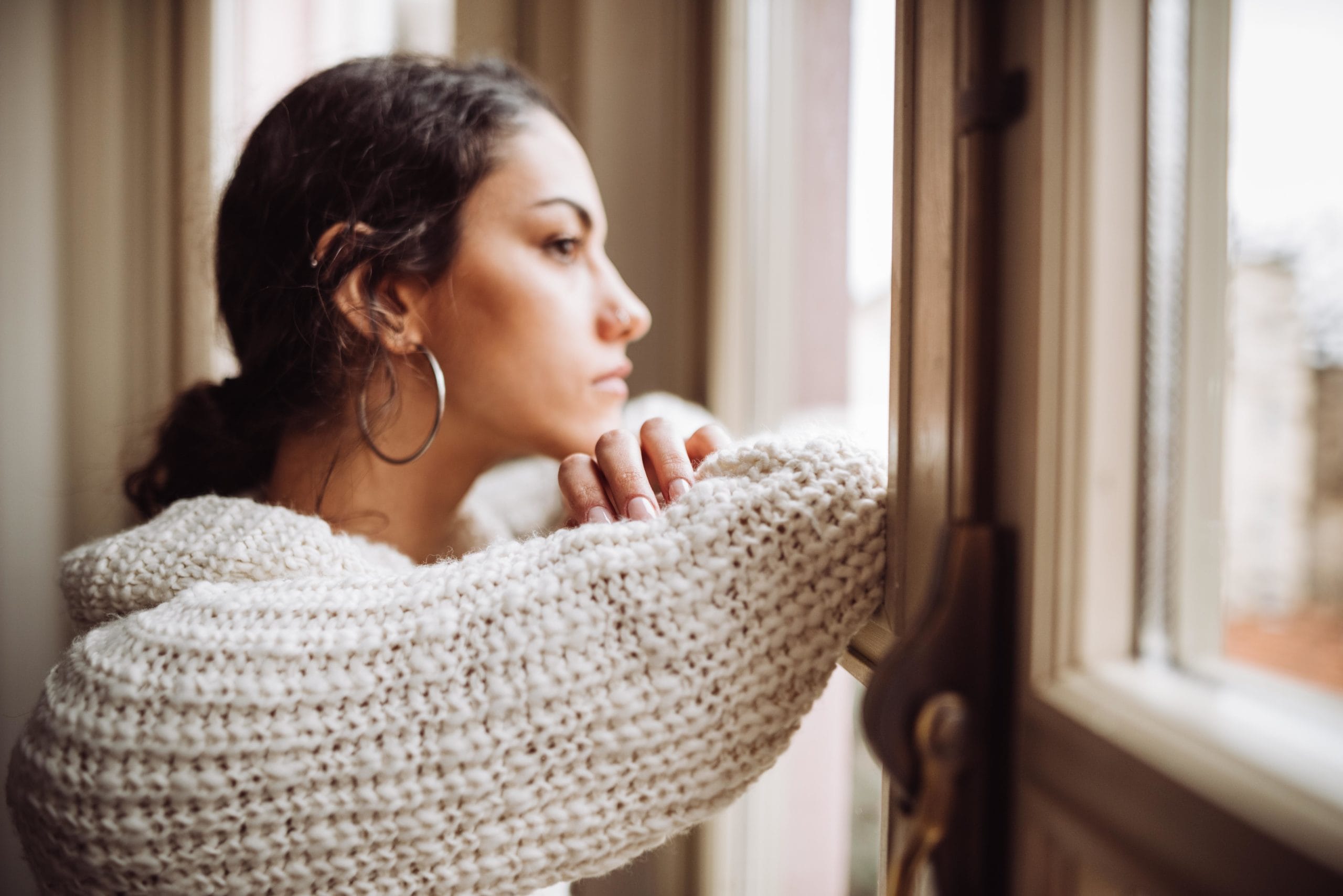 woman looking out window