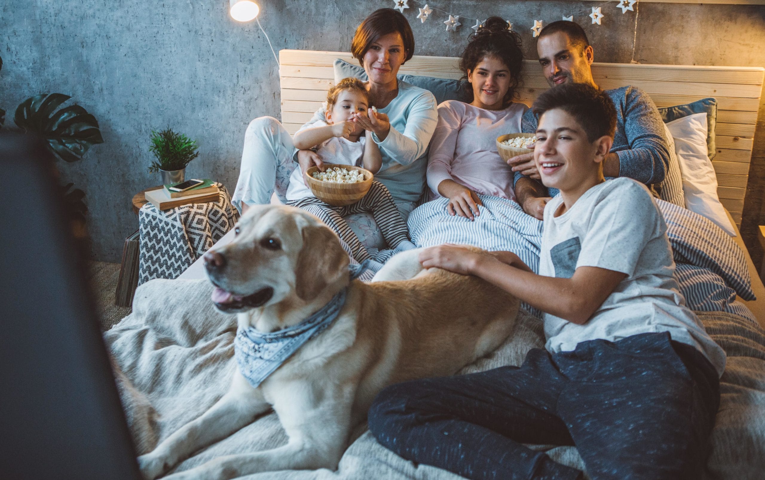 family watching a movie on the couch together