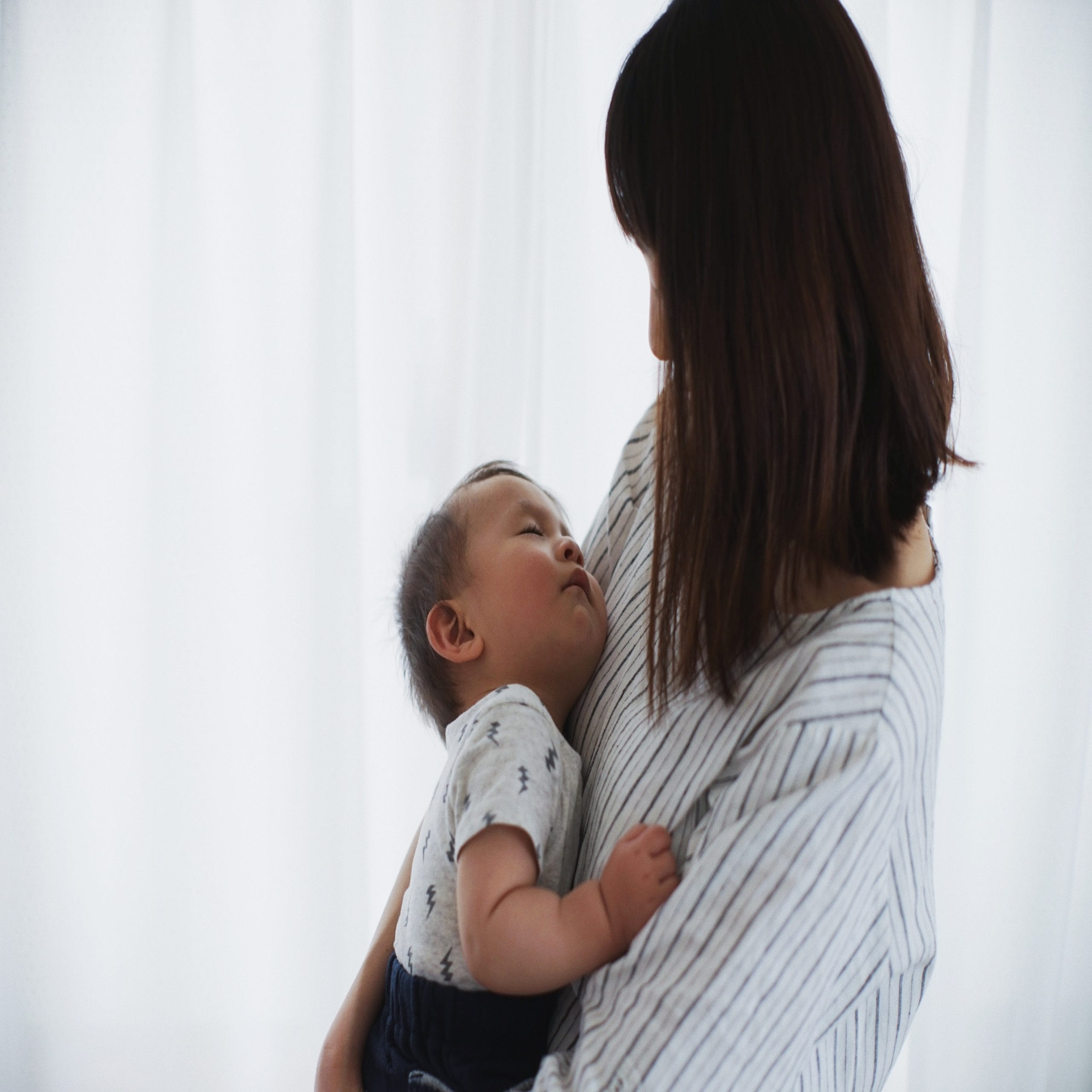 mom holding newborn baby- getting sober