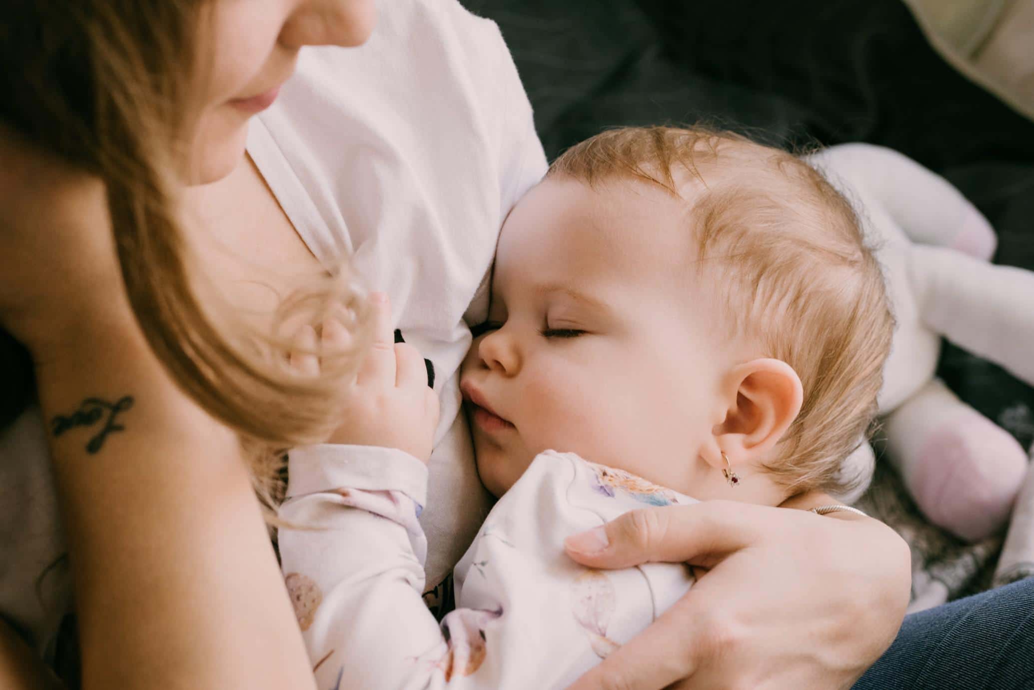 mom holding sleeping baby