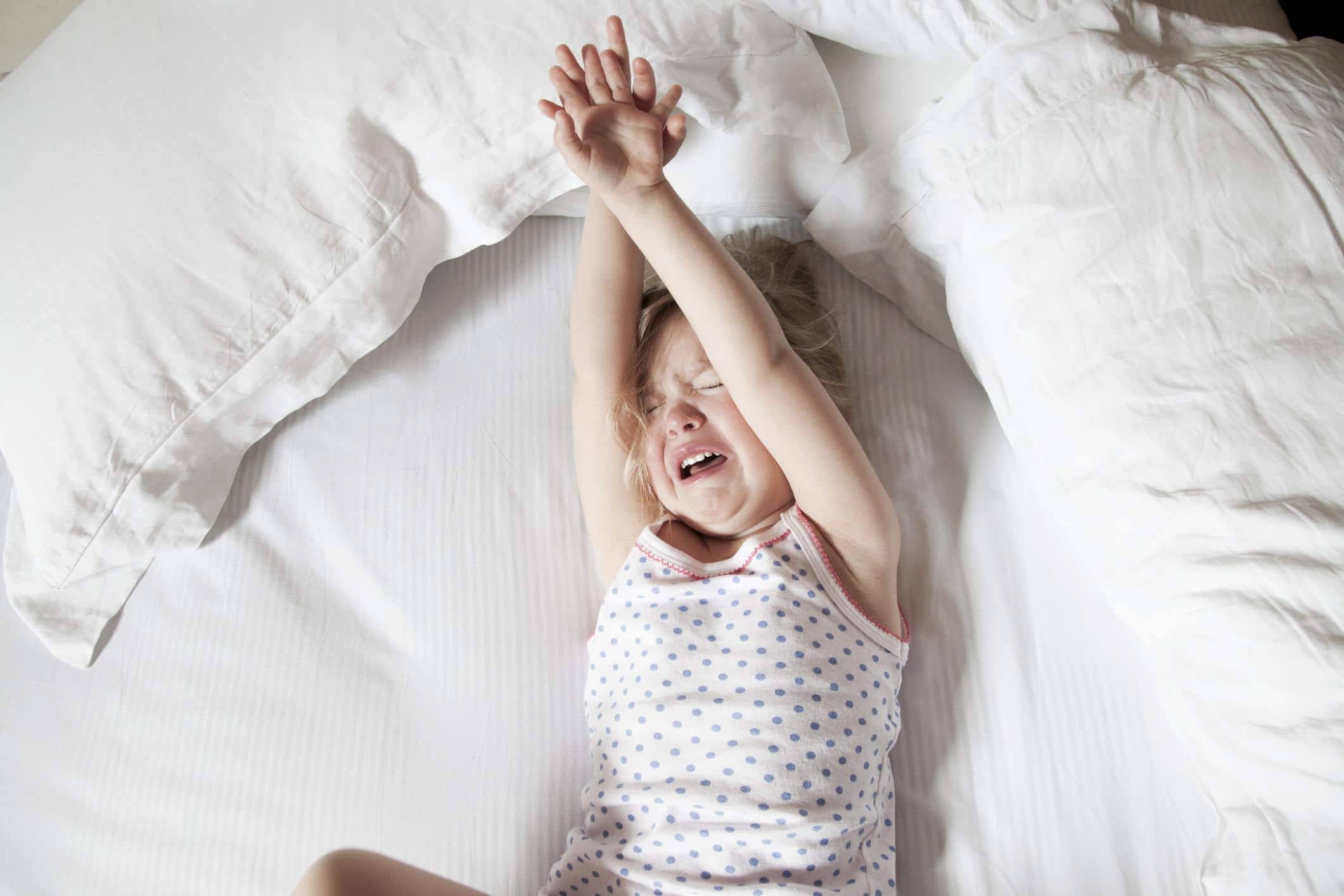 little girl playing on a bed