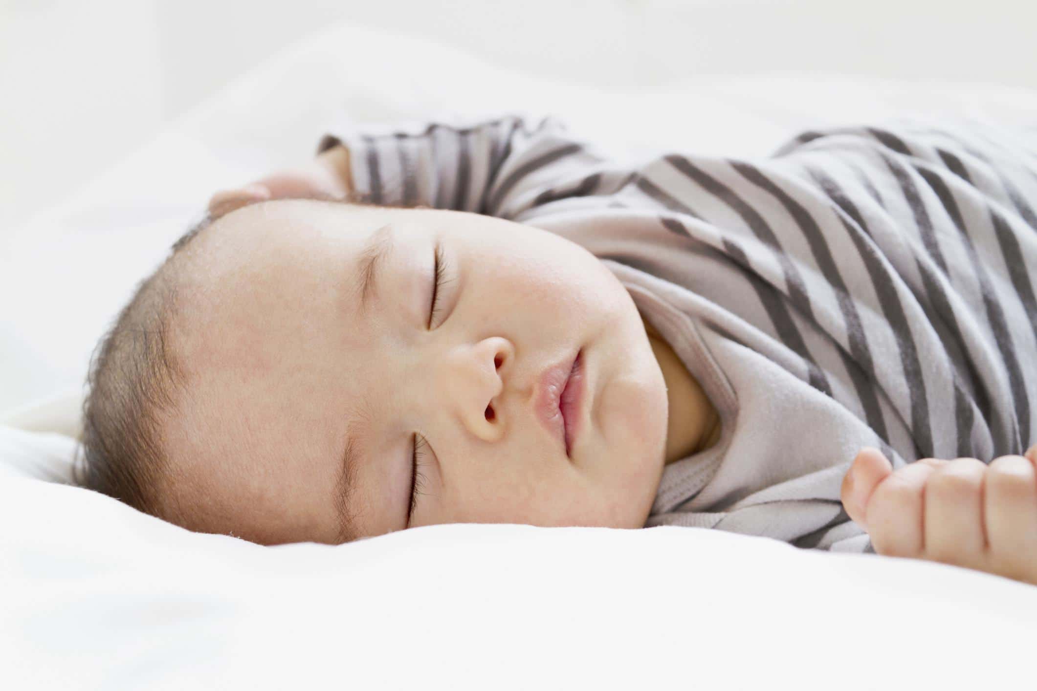 eight-week-old baby sleeping on its back