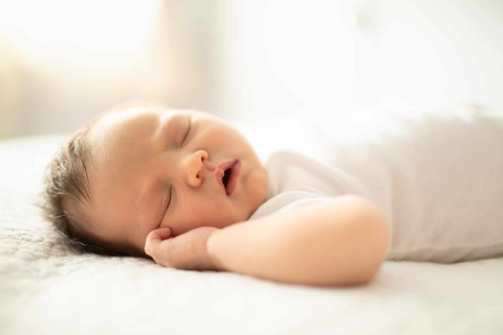 five-week-old baby sleeping on its back