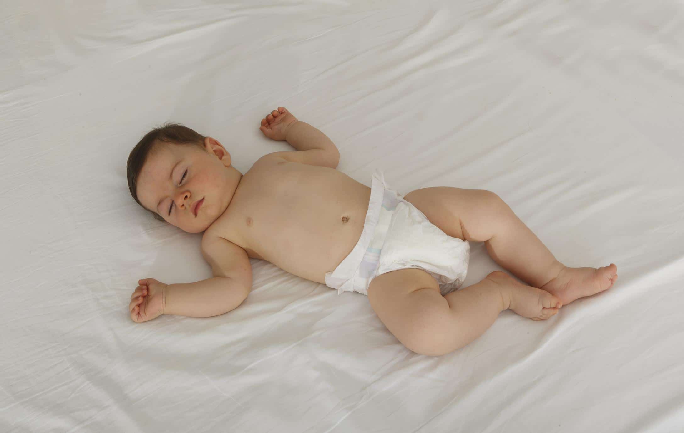 15-week-old baby sleeping on a bed