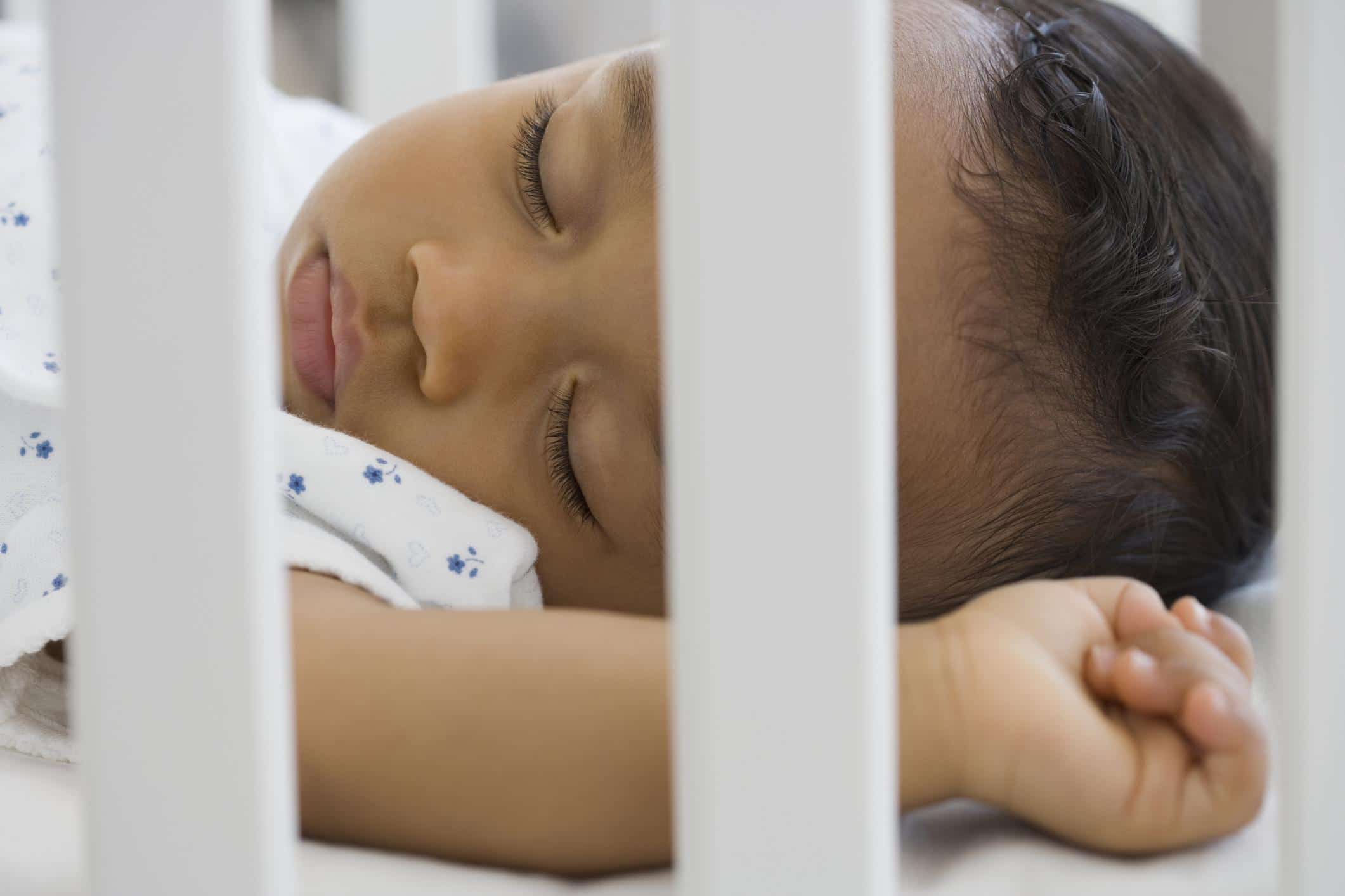 14-week-old baby sleeping in a crib