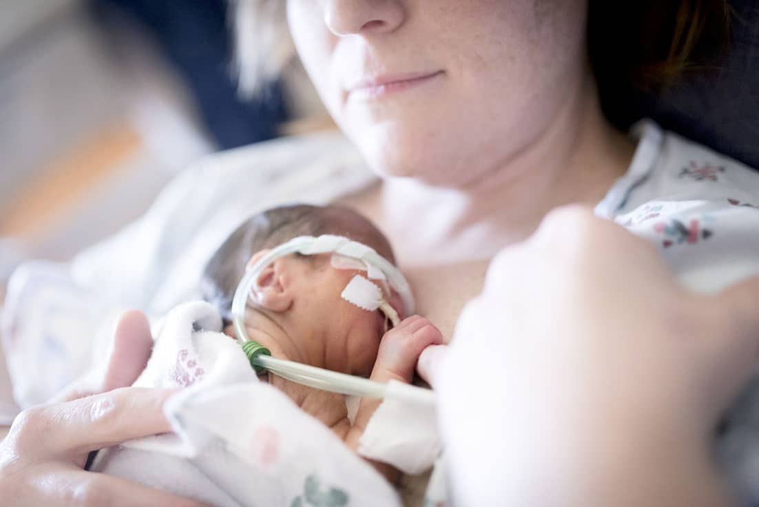 mom holding baby in the NICU