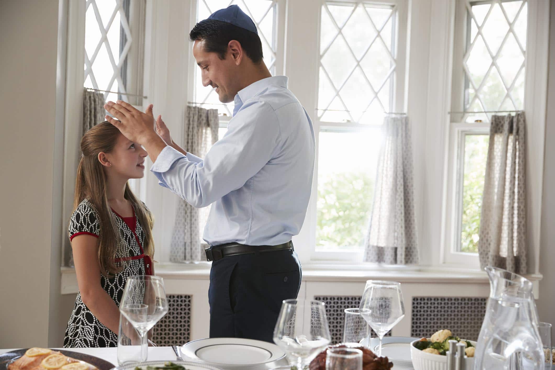 father blessing daughter with his hands - how to teach kids about jewish history