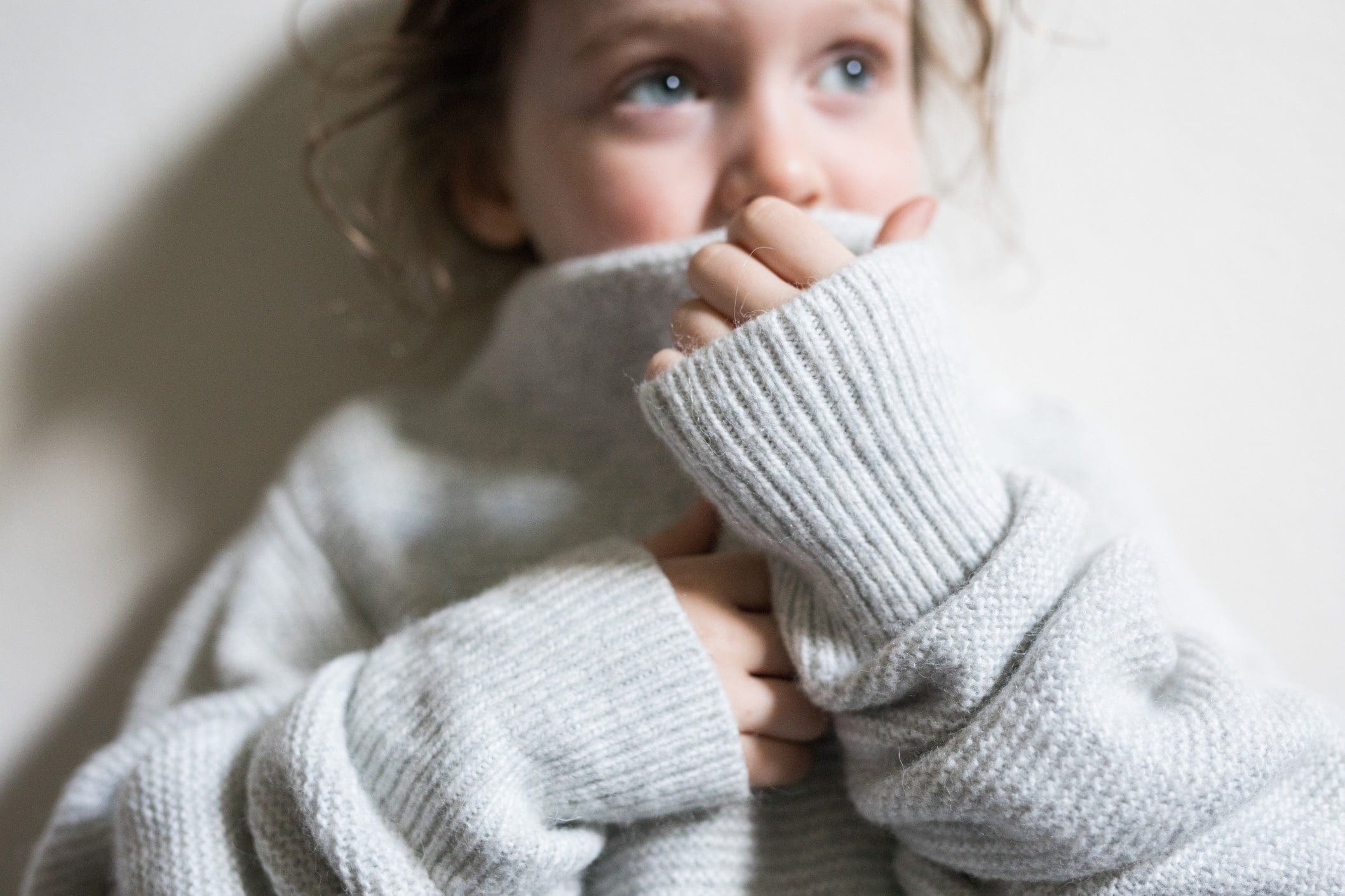 toddler covering up her mouth