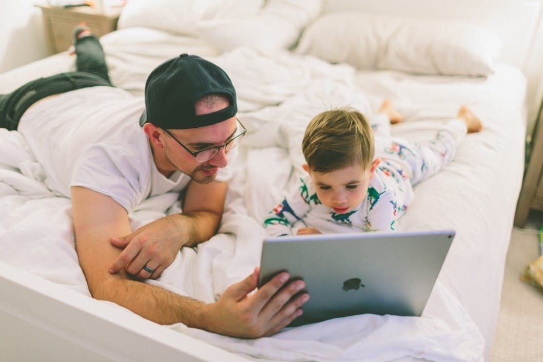 dad and son watching something on a screen