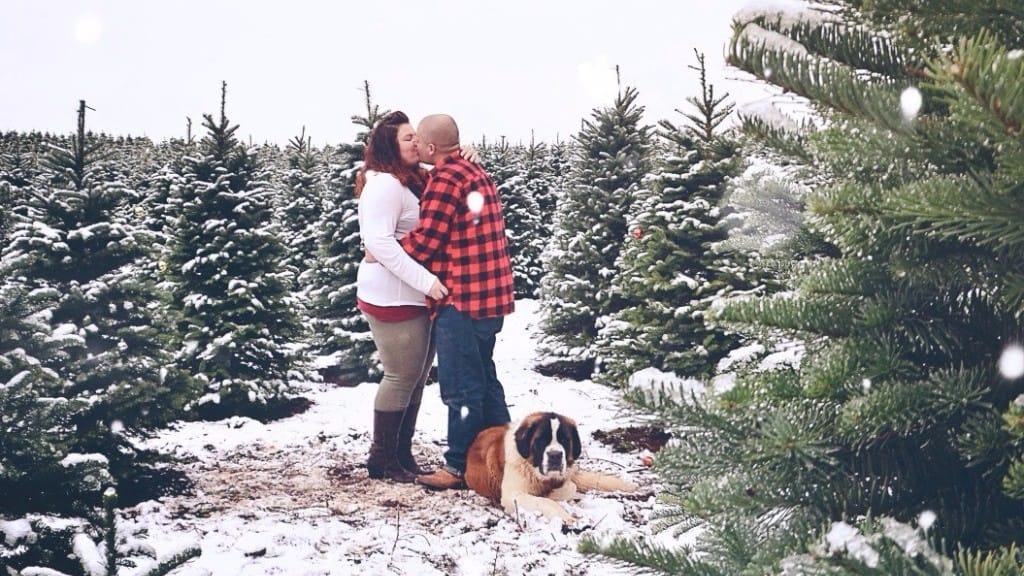 Couple standing outside in snow kissing