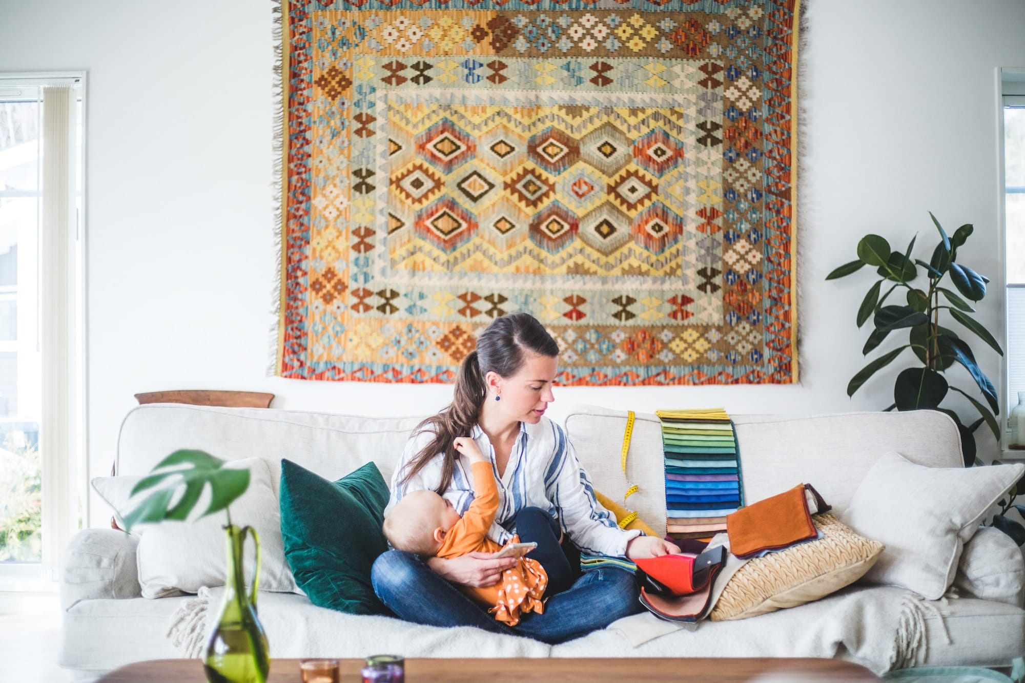 mom on a computer while holding a baby