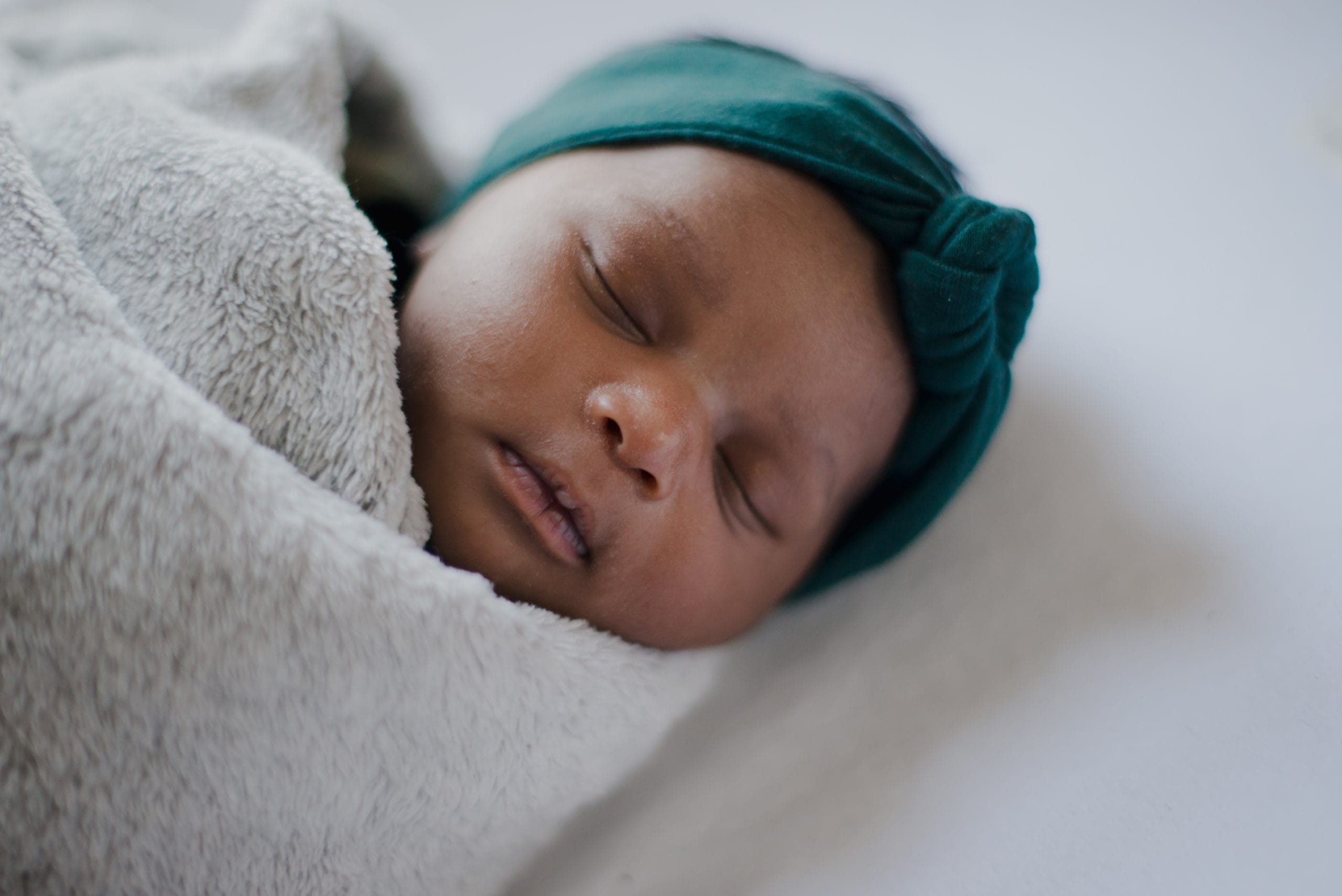 baby sleeping swaddled in a soft blanket