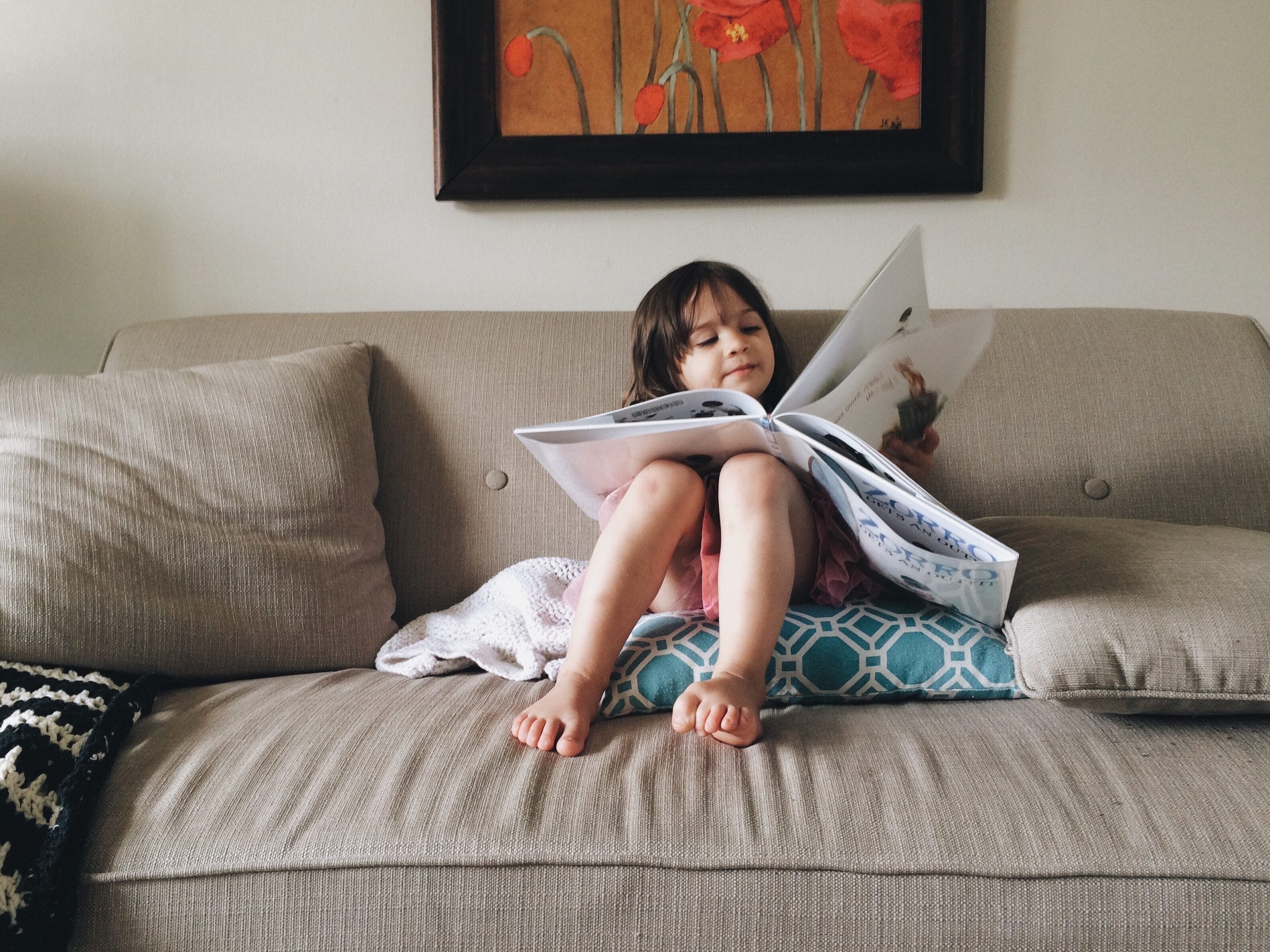 child reading book- international day of the girl