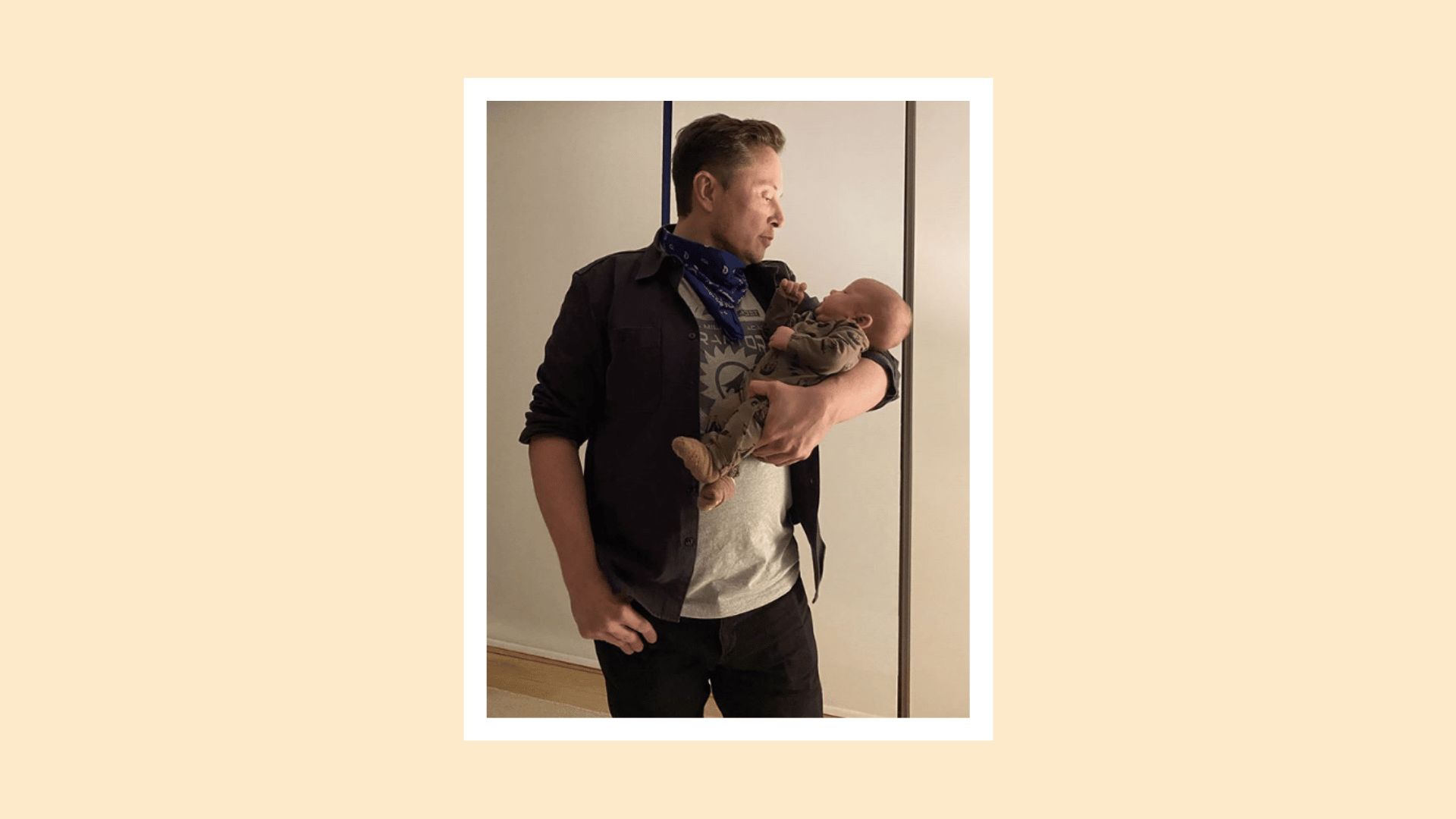 Elon Musk holding his child