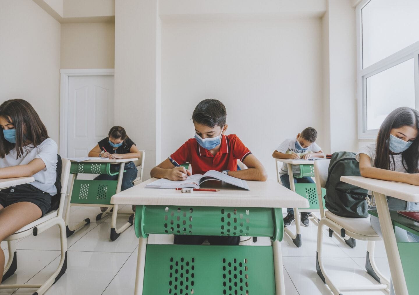 Children studying in class with face mask during pandemic