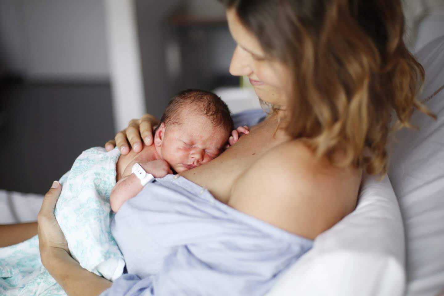 A newborn and his mother at maternity ward