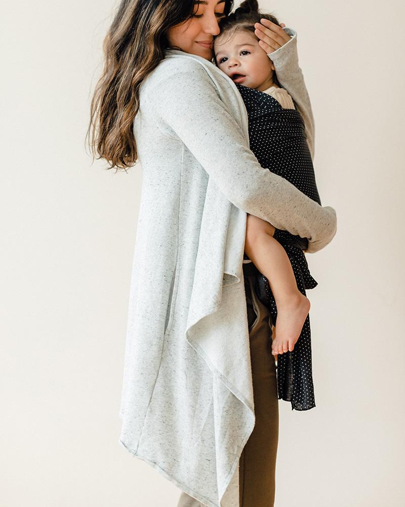 Mom holding baby in front carrier