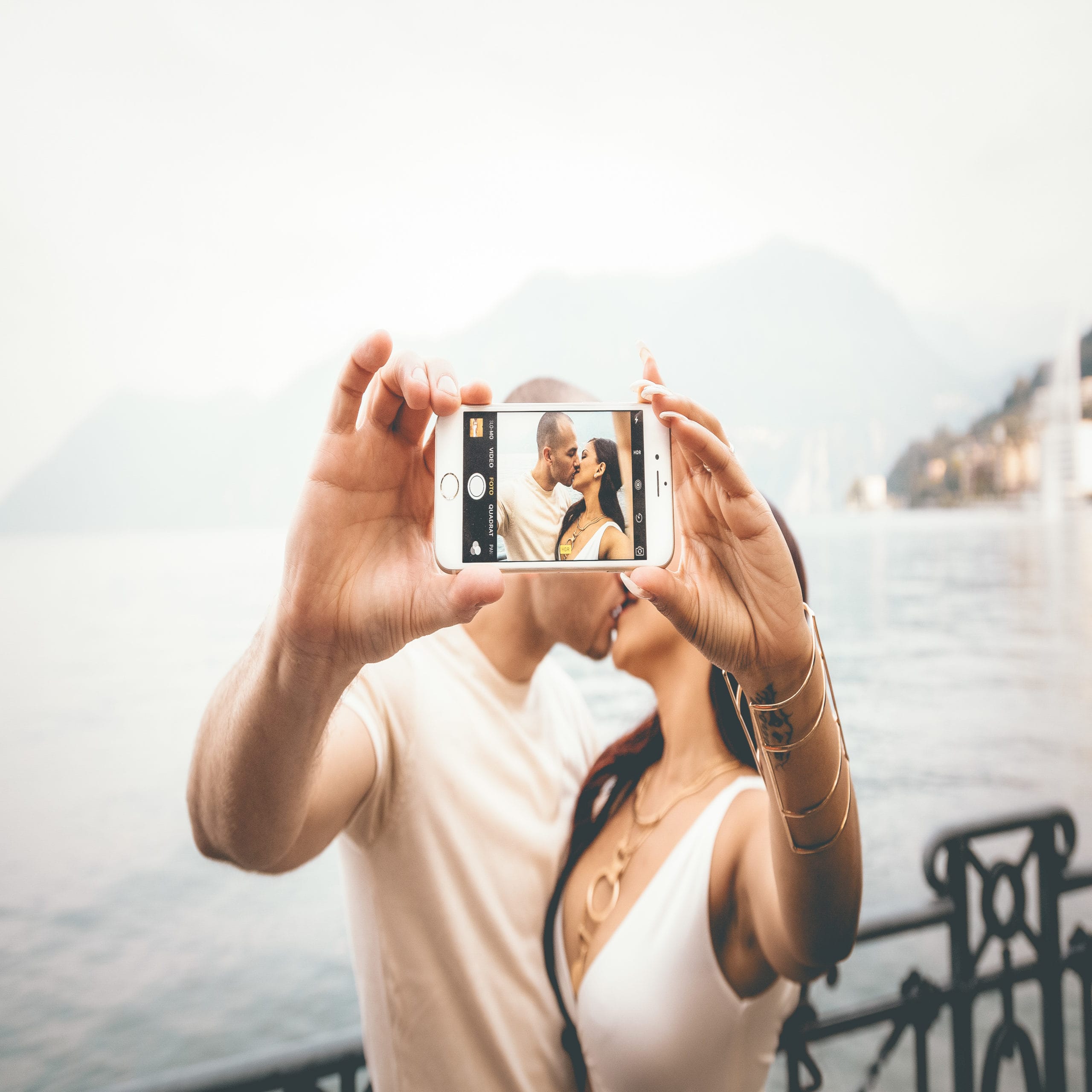 couple kissing in selfie