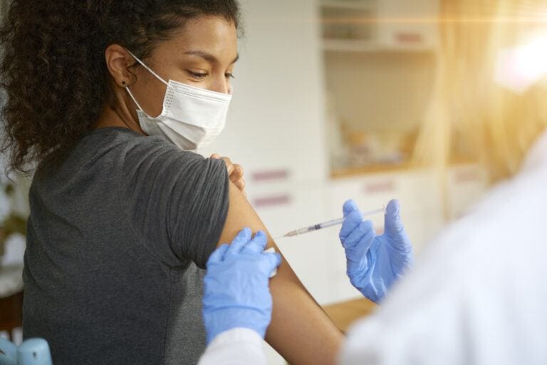 Young woman getting vaccinated