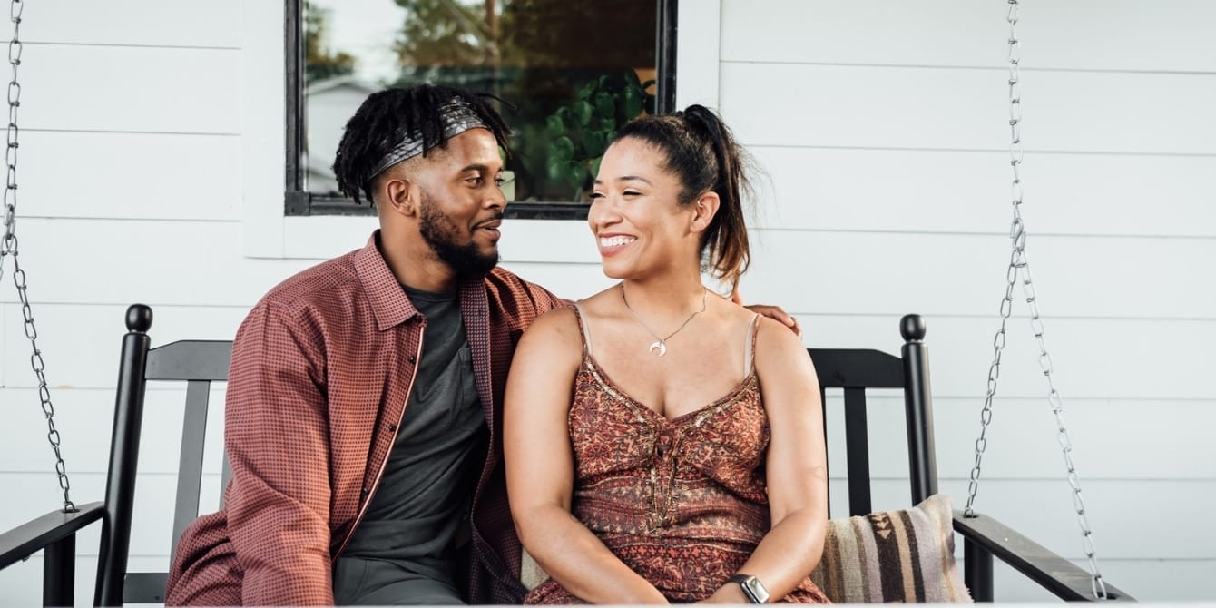 parents sitting outside their house hoping to have a date night after baby