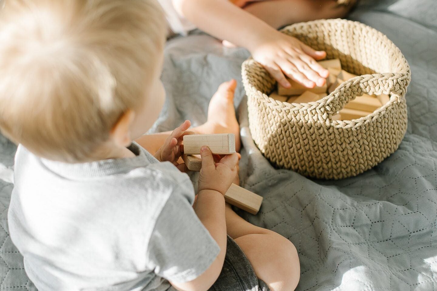 toddler playing with wooden toys -benefits of montessori education