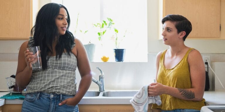 two women in kitchen talking - family facing cancer