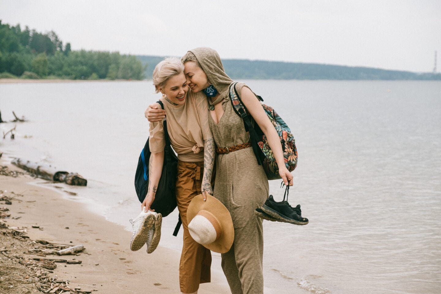 two women hugging on the beach - how to stay in love with your spouse