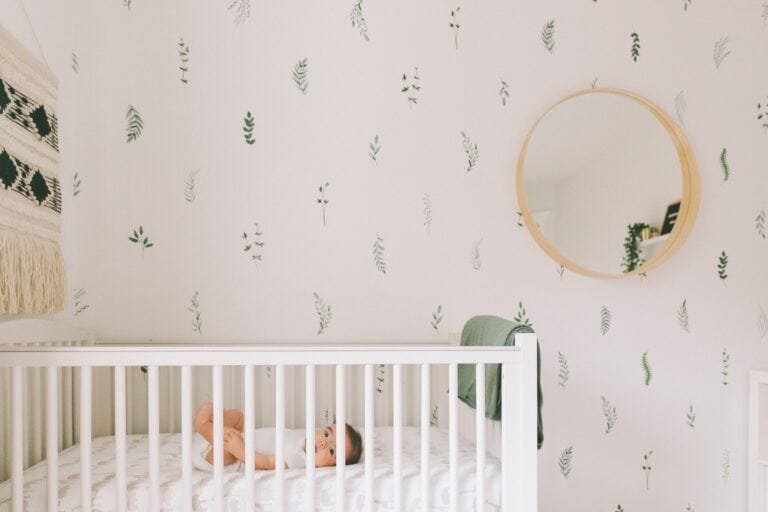 short naps: baby lying awake in crib in nursery