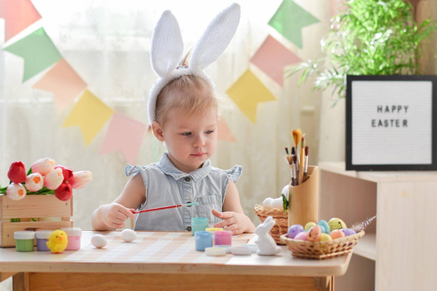 little girl at easter doing easter coloring pages