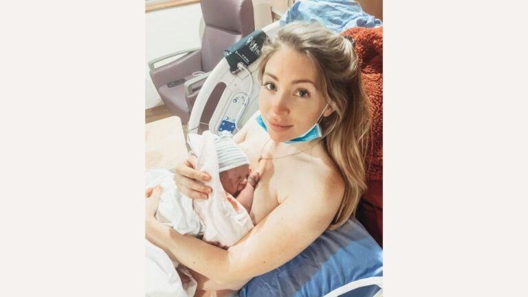 mom in hospital bed holding newborn baby