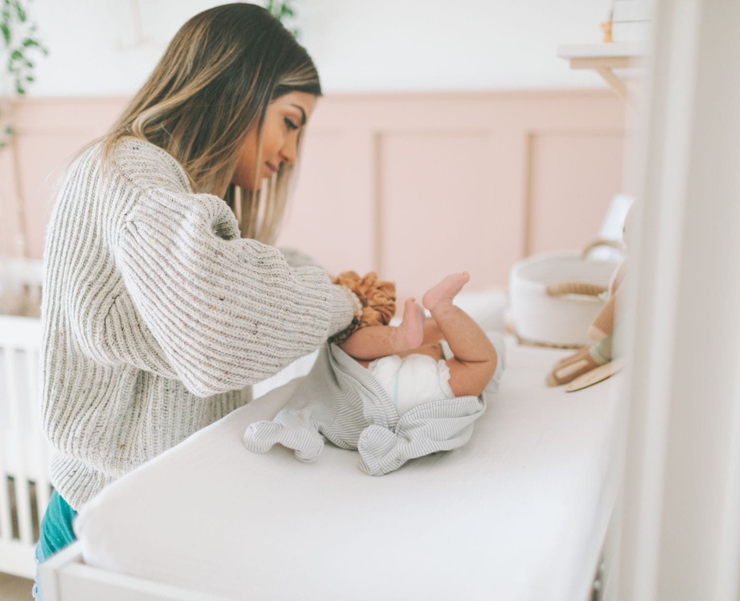 mom changing baby's diaper using a wipe warmer