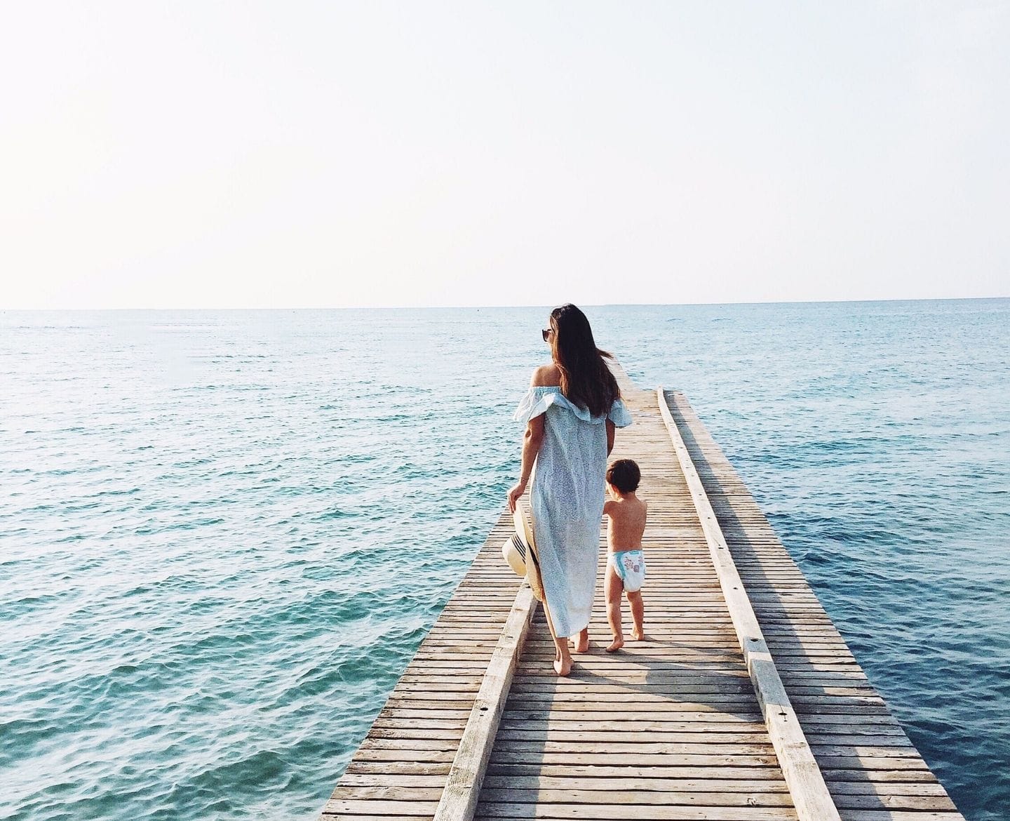 Mom and toddler standing on a dock